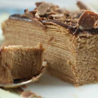 Toblerone Chocolate Crepe Cake - 30 crepes layered with Toblerone ganache and topped with a dark chocolate glaze. A simple, delicious and beautiful cake for entertaining.